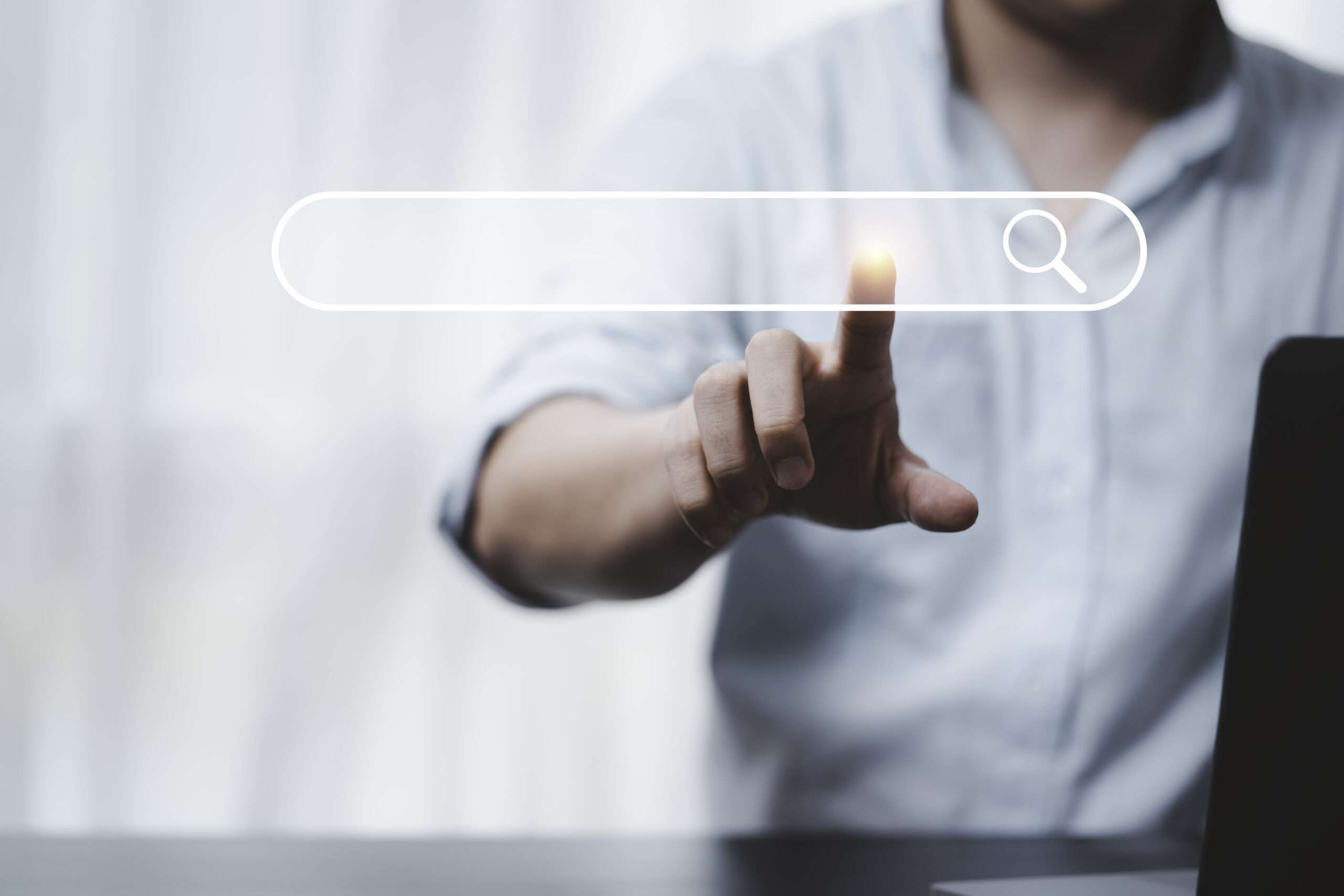 Hand touching with search icon for Search Engine Optimisation or SEO concept to find information by internet connection