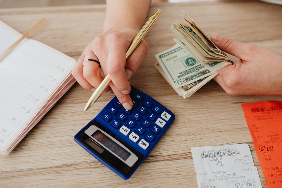 A calculator and notebook used to compare platform costs