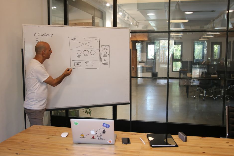 A designer planning a website layout and hierarchy