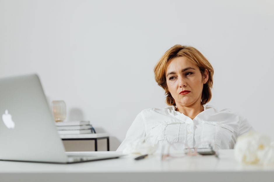 A business owner reviewing a suspension notice on a laptop