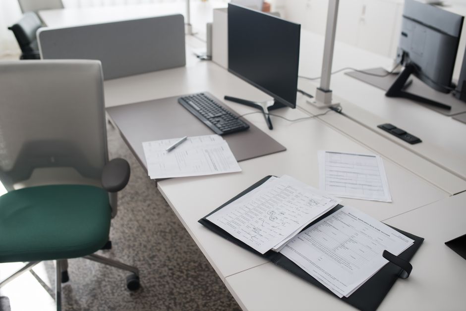 Business documents and paperwork on a desk, used as proof during a reinstatement appeal