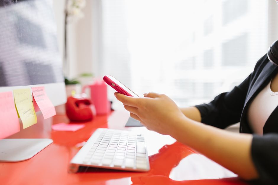 Business owner juggling multiple social media apps on a phone