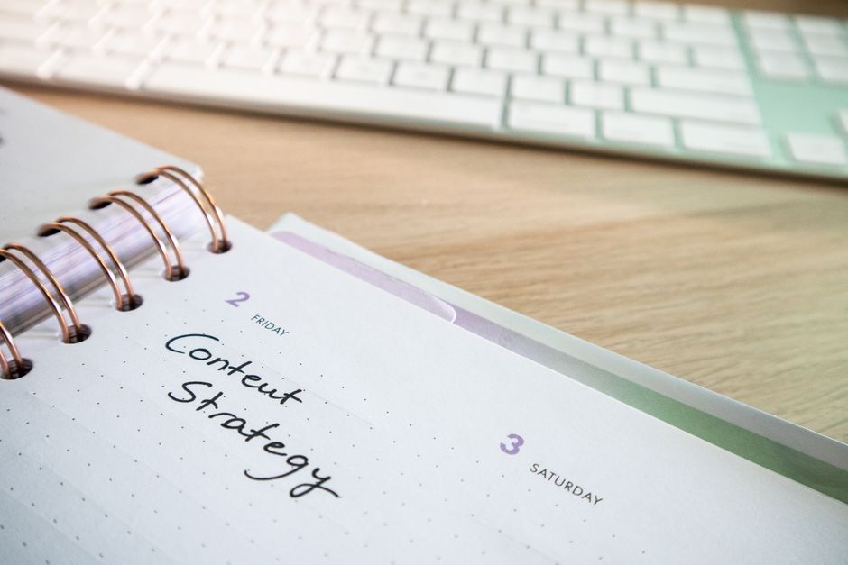 Weekly social media content calendar planned out on a desk