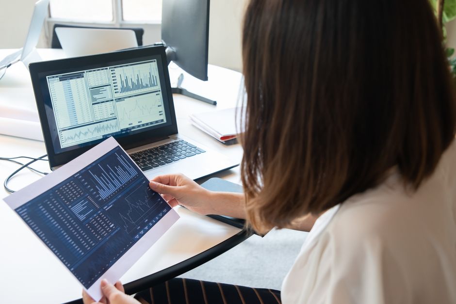 Business owner reviewing advertising performance charts on a laptop