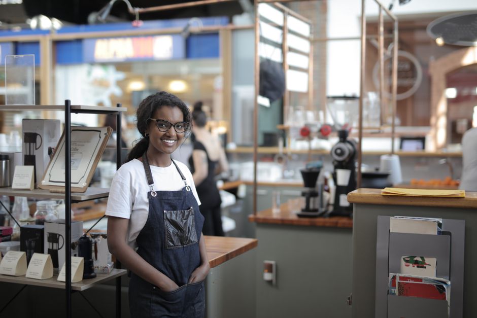 Friendly small business owner in their shop ready to film