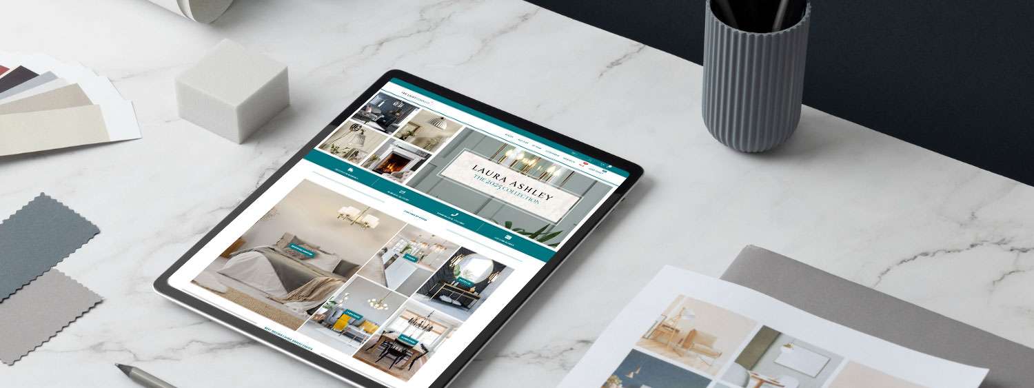 Website design shown on a tablet beside colour swatches on a desk