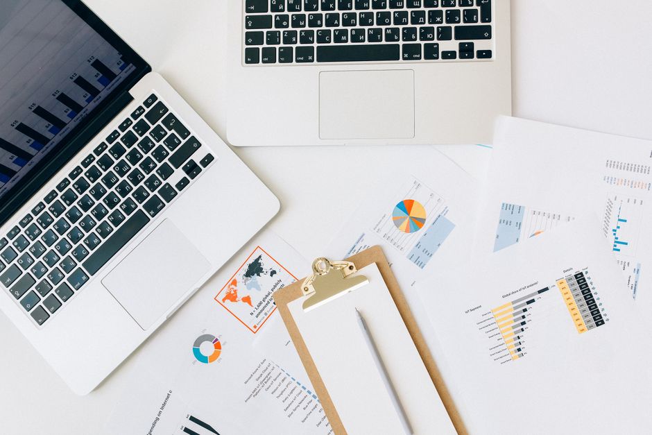 Small business owner reviewing a monthly SEO report with charts on a laptop